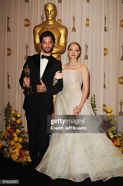 Composer Ryan Bingham and actress Amanda Seyfried pose in the press room at the 82nd Annual Academy Awards held at Kodak Theatre on March 7, 2010 in...