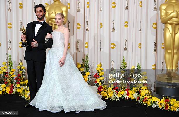 Musician Ryan Bingham, winner of Best Song award for "The Weary Kind" , and presenter actress Amanda Seyfried pose in the press room at the 82nd...