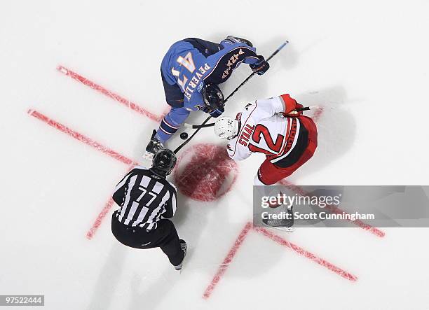 Rich Peverley of the Atlanta Thrashers wins a faceoff against Eric Staal of the Carolina Hurricanes at Philips Arena on March 7, 2010 in Atlanta,...