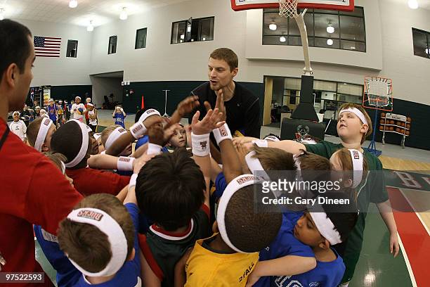 Luke Ridnour of the Milwaukee Bucks participates in the annual YMCA basketball clinic on March 7, 2010 at The Bucks Training Center in Milwaukee,...