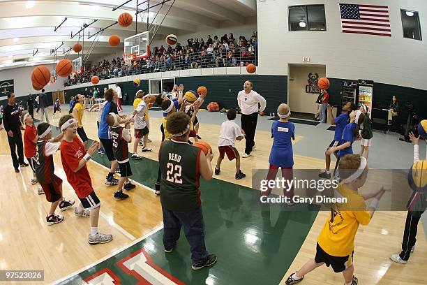 Milwaukee Bucks assistant coach Bill Peterson leads participants through ball handling drills during the annual YMCA basketball clinic on March 7,...