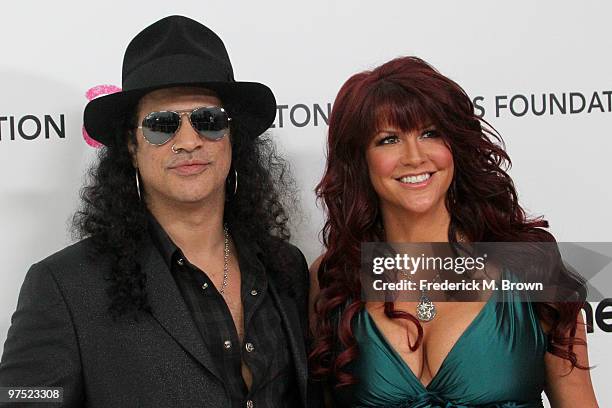 Musician Slash and his wife Perla Ferrar arrive at the 18th annual Elton John AIDS Foundation Oscar Party held at Pacific Design Center on March 7,...