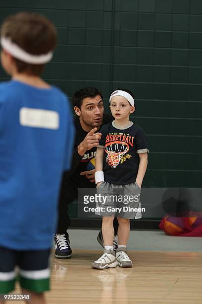 Carlos Delfino of the Milwaukee Bucks participates in the annual YMCA basketball clinic on March 7, 2010 at The Bucks Training Center in Milwaukee,...