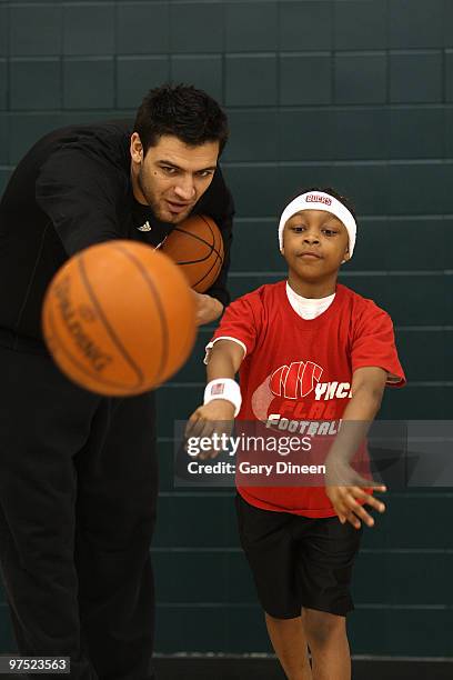 Carlos Delfino of the Milwaukee Bucks participates in the annual YMCA basketball clinic on March 7, 2010 at The Bucks Training Center in Milwaukee,...