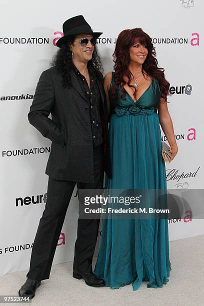 Musician Slash and his wife Perla Ferrar arrive at the 18th annual Elton John AIDS Foundation Oscar Party held at Pacific Design Center on March 7,...