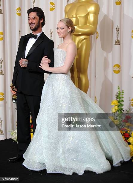 Musician Ryan Bingham, winner of Best Song award for "The Weary Kind" , and presenter actress Amanda Seyfried pose in the press room at the 82nd...