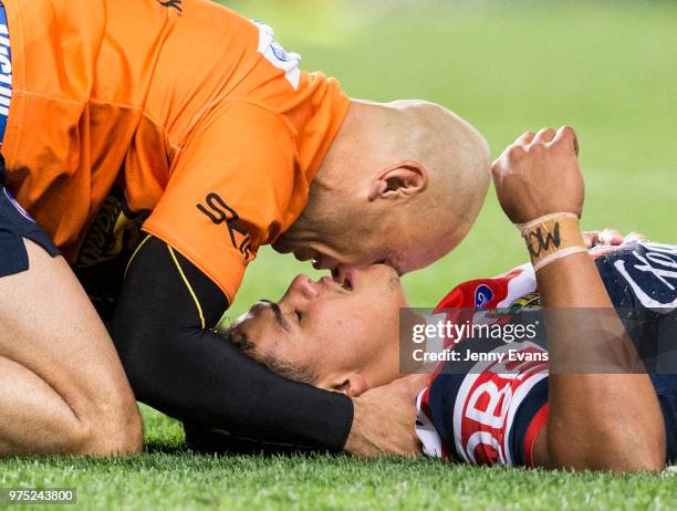 Latrell Mitchell of the Roosters lays injured on the ground during the round 15 NRL match between the Sydney Roosters and the Penrith Panthers at...