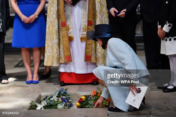 Jane Hawking places flowers at the site of the internment of the ashes of British scientist Stephen Hawking in the nave of Westminster Abbey on June...