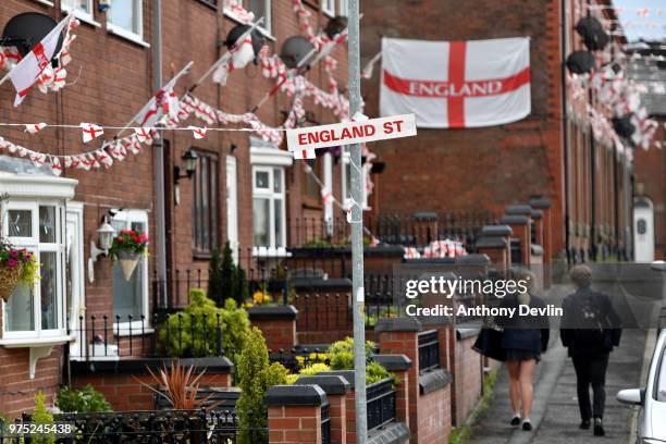 School children walk along Wales Street in Oldham which local residents have re-named England Street and decorated with flags to celebrate the FIFA...