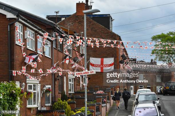 School children walk along Wales Street in Oldham which local residents have re-named England Street and decorated with flags to celebrate the FIFA...