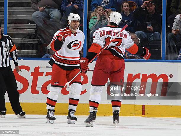 Rod Brind'Amour of the Carolina Hurricanes is congratulated by Tom Kostopoulos after scoring a 3rd period goal against the Atlanta Thrashers at...