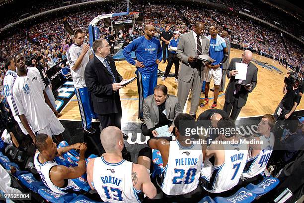 Head coach Stan Van Gundy of the Orlando Magic, along with assistant coaches Brendan Malone, Patrick Ewing and Steve Clifford, huddle with players...