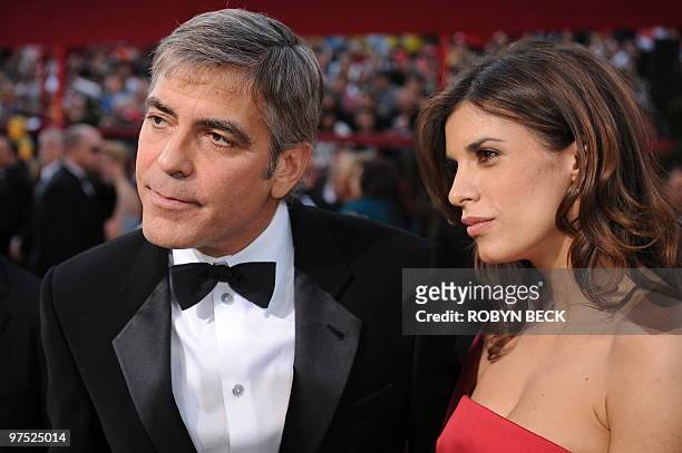 Actor George Clooney listens to a reporter's question as he arrives with model Elisabetta Canalis at the 82nd Academy Awards at the Kodak Theater in...
