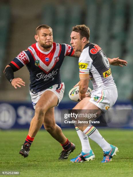 James Maloney of the Panthers runs with the ball as Jared Waerea-Hargreaves of the Roosters goes in for the tackle during the round 15 NRL match...