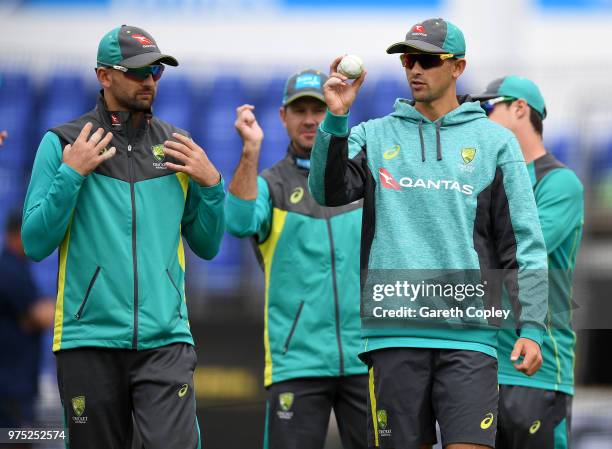 Nathan Lyon of Australia speaks with Ashton Agar during a nets session at SWALEC Stadium on June 15, 2018 in Cardiff, Wales.