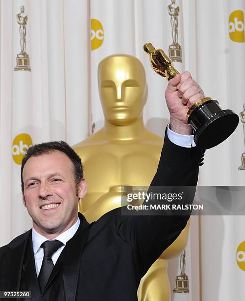 Mauro Fiore of Italy celebrates his Oscar for Achievement in Cinematography for "Avatar" during the 82nd Academy Awards at the Kodak Theater in...