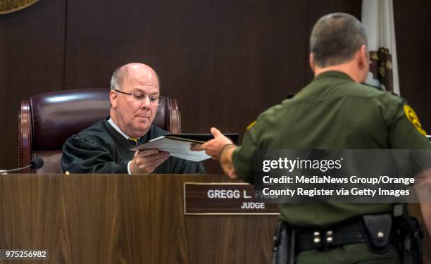 The bailiff hands the jury's death sentence recommendation to Orange County Superior Court Judge Gregg L. Prickett for Andrew Urdiales, an eight time...