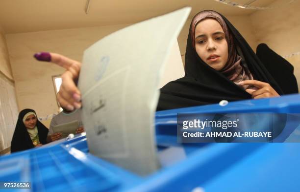 An Iraqi woman casts her ballot in her country's general elections on March 7, 2010 in Baghdad's Sadr City. Iraqis defied waves of bomb, mortar and...