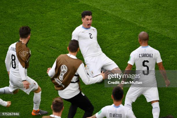 Jose Gimenez of Uruguay celebrates after scoring his team's first goal with team mates during the 2018 FIFA World Cup Russia group A match between...