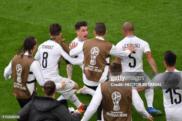 Uruguay's defender Jose Gimenez celebrates with team-mates after scoring the opening goal during the Russia 2018 World Cup Group A football match...