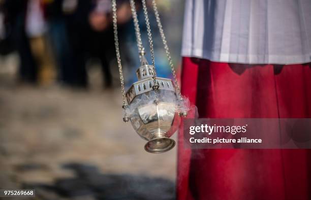 May 2018, Germany, Muenster: An altar boy carries a thurible before the main service of the Catholics Day on the Schlossplatz square. The Catholics...