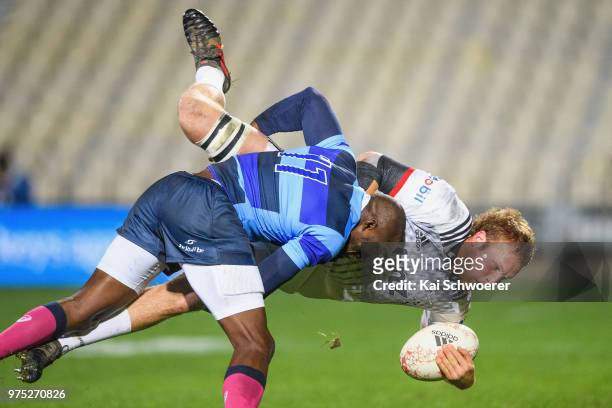 Mitchell Dunshea of the Crusaders is tackled by Djibril Camara of the French Barbarians during the match between the Crusaders and the French...