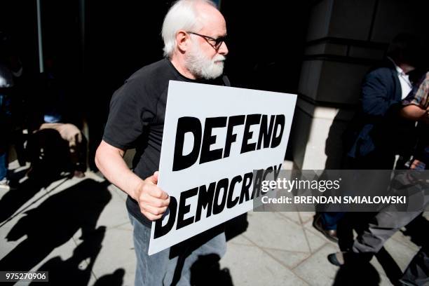 Protester walks past after former Trump campaign chairman Paul Manafort arrived for a hearing at federal court June 15, 2018 in Washington, DC. -...