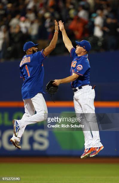 Amed Rosario and Jay Bruce of the New York Mets celebrate their 2-0 win over the New York Yankees during a game at Citi Field on June 10, 2018 in the...