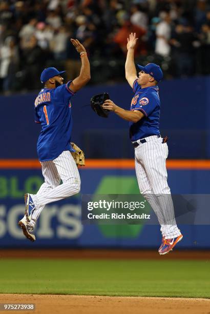 Amed Rosario and Jay Bruce of the New York Mets celebrate their 2-0 win over the New York Yankees during a game at Citi Field on June 10, 2018 in the...