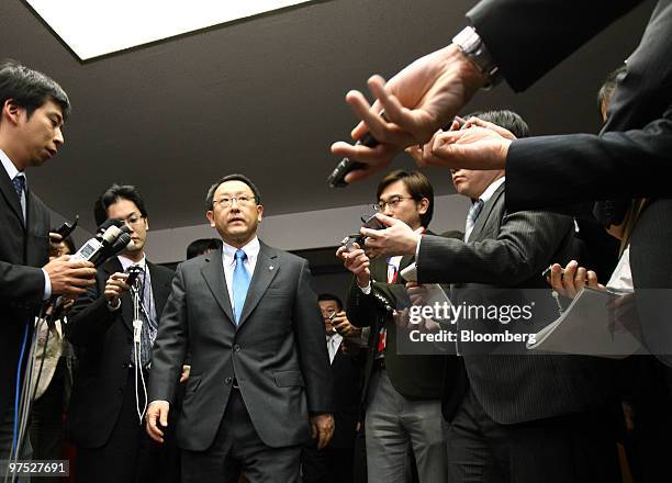 Akio Toyoda, president of Toyota Motor Corp., is surrounded by reporters as he leaves a meeting with Seiji Maehara, Japan's minister for land and...
