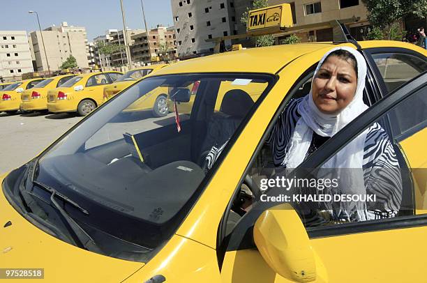 Egyptian taxi driver Ines Hassan gets into her car in Cairo on March 6, 2010. The 36-year-old taxi driver is one of several women driving special...