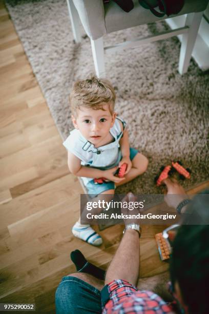 uncle and nephew playing with new plastic block toys - uncle nephew stock pictures, royalty-free photos & images