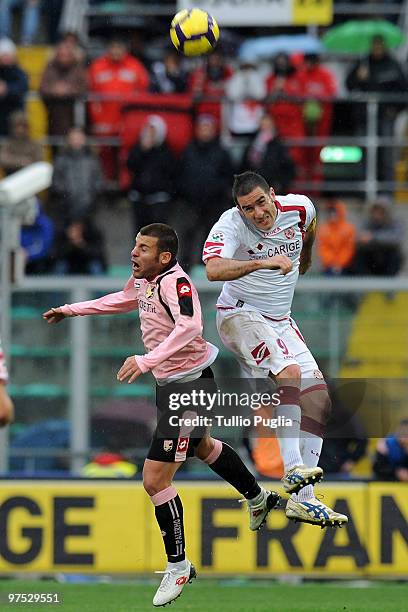 Livorno compete for a header during the Serie A match between US Citta di Palermo and AS Livorno Calcio at Stadio Renzo Barbera on March 7, 2010 in...