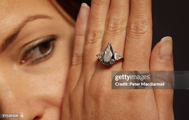 Sotheby's employee displays a 5.16 carat pear shaped fancy vivid blue diamond ring, at Sotheby's on March 8, 2010 in London, England. The internally...