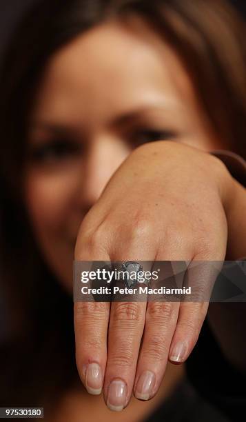 Sotheby's employee displays a 5.16 carat pear shaped fancy vivid blue diamond ring, at Sotheby's on March 8, 2010 in London, England. The internally...