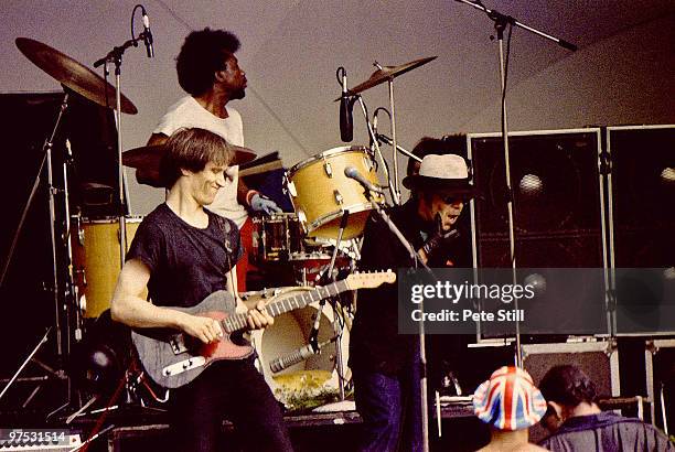 Wilko Johnson joins drummer Charley Charles and Ian Dury of Ian Dury and The Blockheads on stage at the Crystal Palace Bowl on July 29th, 1981 in...