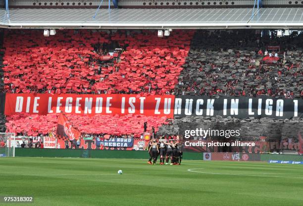 May 2018, Germany, Nuremberg: Soccer, 2. Bundesliga, 1. FC Nuremberg vs Fortuna Duesseldorf at the Max-Morlock-Stadium. Nuremberg's fans hold up a...