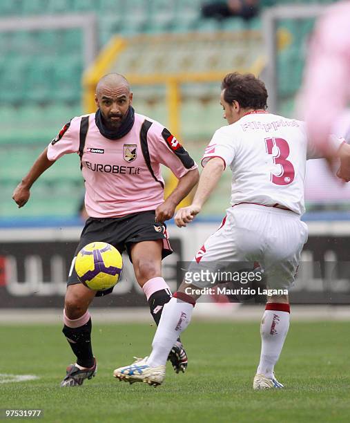 Fabio Liverani of US Citta' di Palermo battles for the ball with Antonio Filippini of AS Livorno Calcio during the Serie A match between US Citta di...