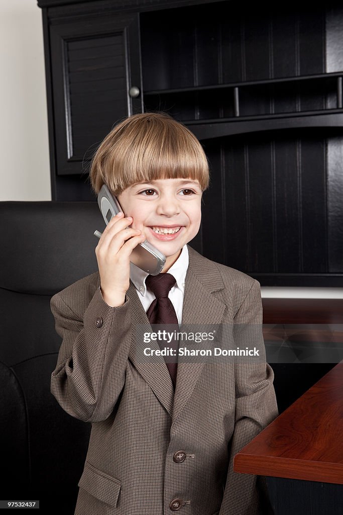 Boy Dressed as a Businessman Talking on Cell Phone