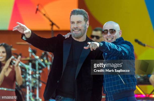 Actor John Tavolta and Rapper Pitbull attend Pitbull's performance on ABC's "Good Morning America" at Rumsey Playfield, Central Park on June 15, 2018...