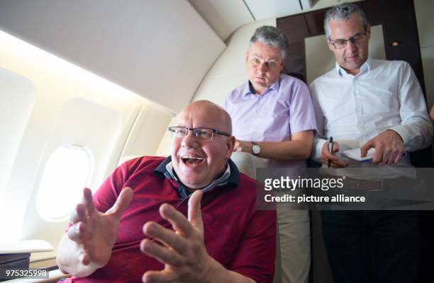 May 2018, Germany, Berlin: Peter Altmaier of the Christian Democratic Union , German Minister for Economic Affairs and Energy, sits inside an Airbus...
