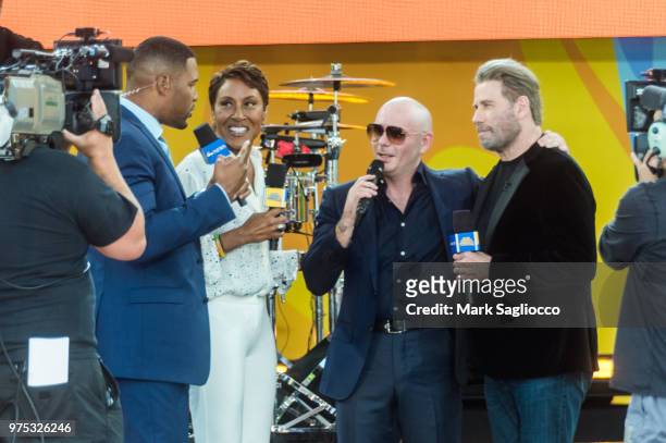 Good Morning America Co-Host Robin Robins, Rapper Pitbull and Actor John Travolta attend Pitbull's performance on ABC's "Good Morning America" at...
