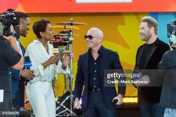 Good Morning America Co-Host Robin Robins, Rapper Pitbull and Actor John Travolta attend Pitbull's performance on ABC's "Good Morning America" at...