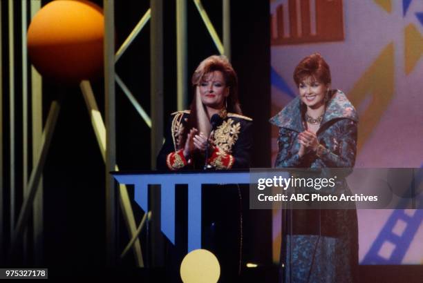 Los Angeles, CA Wynonna Judd, Naomi Judd, The Judds presenting on the 17th Annual American Music Awards, Shrine Auditorium, January 22, 1990.