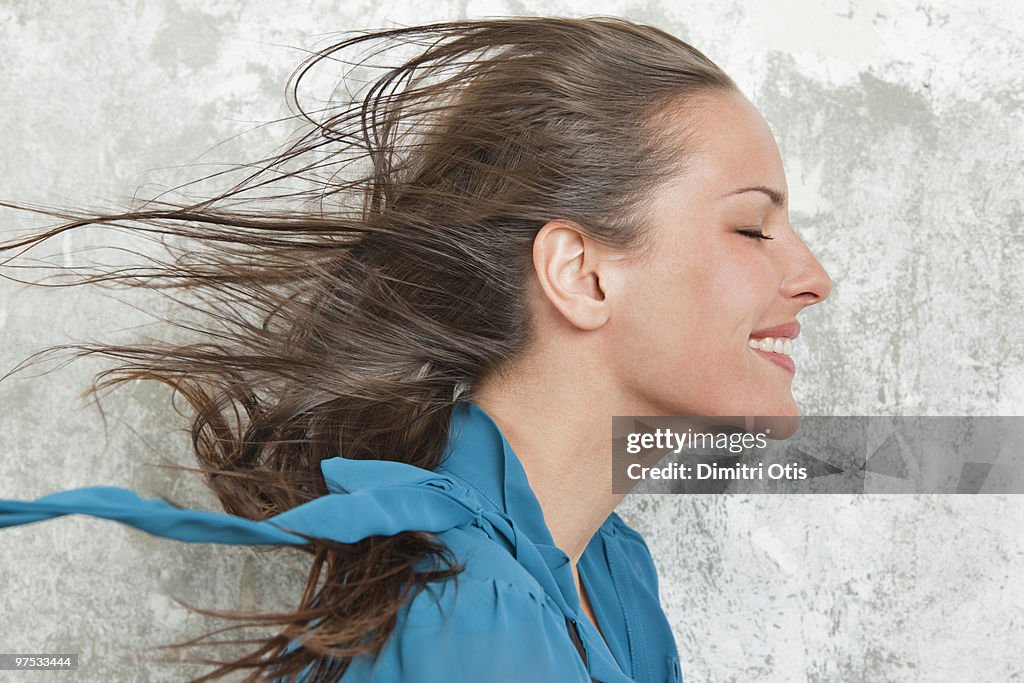Profile of young woman with wind in her hair
