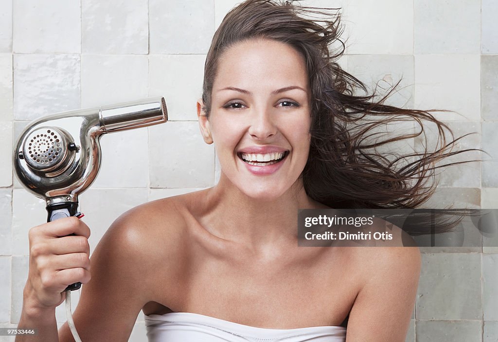 Young woman with hairdryer