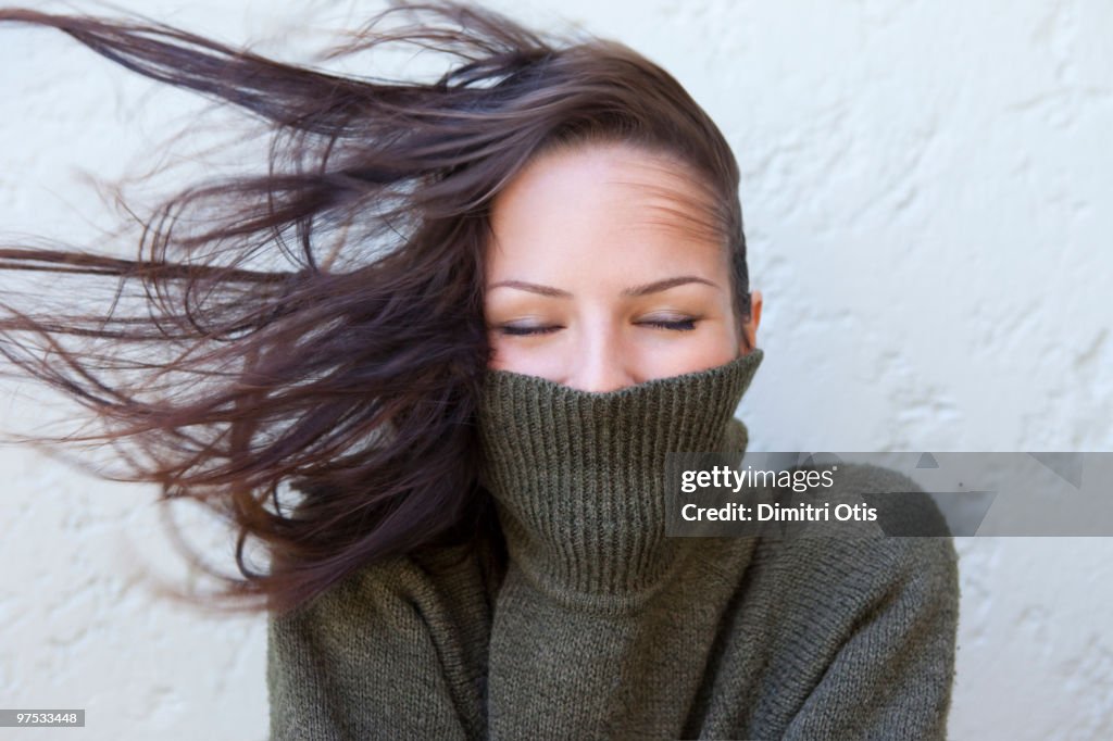 Woman with polar neck jumper and wind in her hair