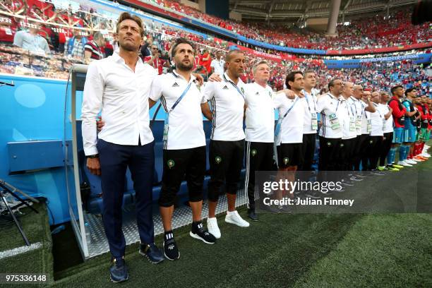 Herve Renard, Head coach of Morocco and his backroom staff sign the national anthem prior to the 2018 FIFA World Cup Russia group B match between...