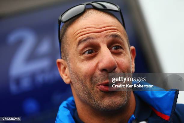 Tony Kanaan of the Ford Chip Ganassi Team is interviewed by the media during previews to the Le Mans 24 Hour race at the Circuit de la Sarthe on June...