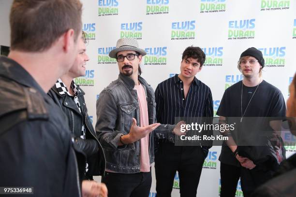 Kevin Richardson of The Backstreet Boys chats with members of 5 Seconds of Summer at "The Elvis Duran Z100 Morning Show" at Z100 Studio on June 15,...